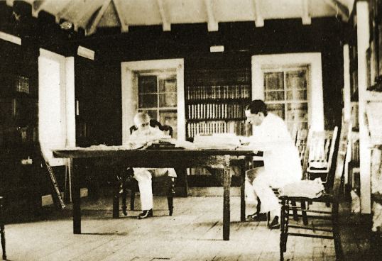 Arthur Valk in back with Irvin Mussenden in the library