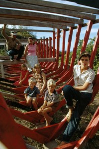A family sits in their unfinished cabin cruiser.